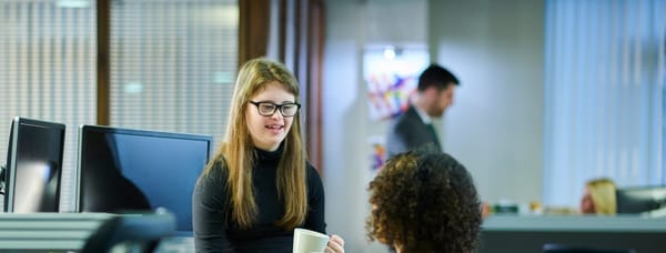 An employee speaks to another