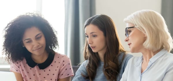 Three women of diverse ages in an office