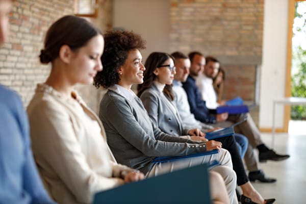 People sit waiting for an interview
