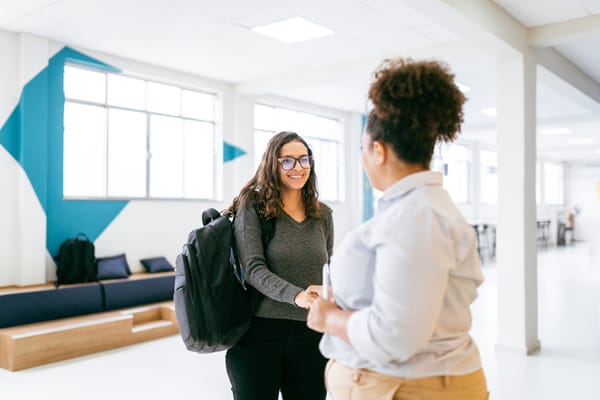 A new employee shakes hands with a colleague