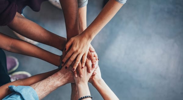 A diverse team participates in a belonging exercise