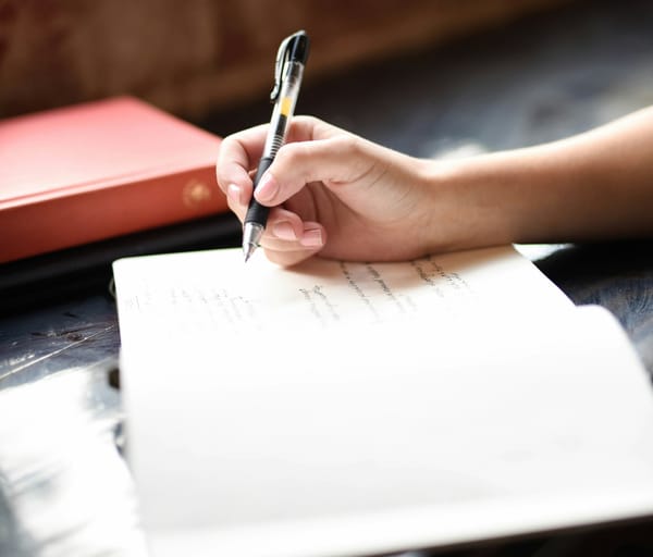 A closup of someone drafting their resume