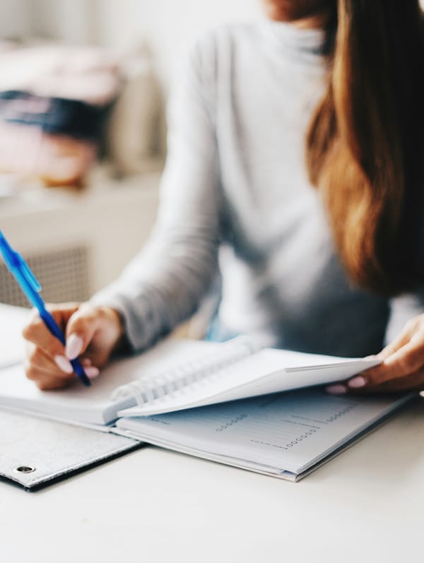 A woman write diversity goals in a journal