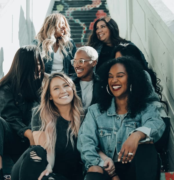 A group fo women sitting on a staircase