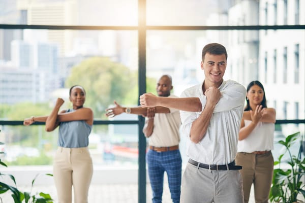 Employees focused on well-being complete a group exercise