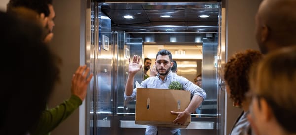 An inclusive group of employees wave goodbye to an employee