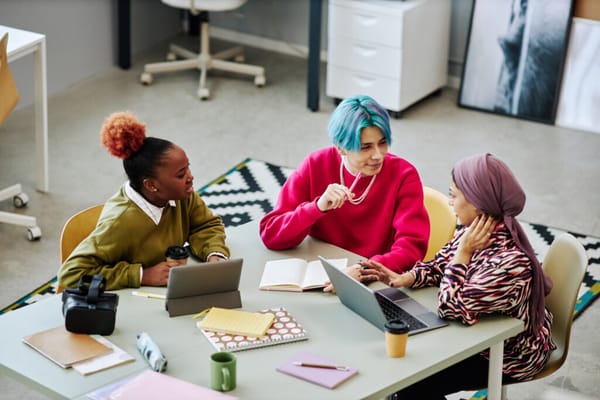 A team of young professionals meet in an office